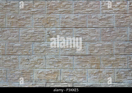 Wall of light texture tiles, stylized in appearance as a brick. One of the types of wall decoration Stock Photo