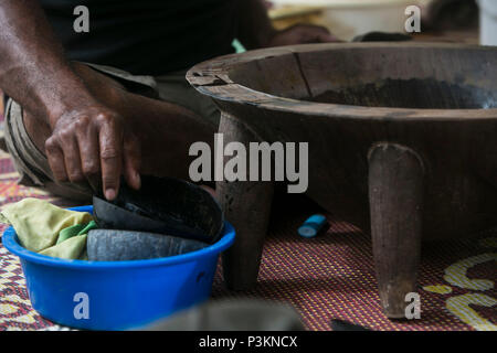 A staff member from St. John’s College, Ovalau, Fiji, makes Kava, a traditional drink made from local roots, during a welcoming ceremony for U.S. Marines and Sailors with Task Force Koa Moana, July 3, 2016, as part of the task force’s deployment in the Asia-Pacific region. The task force is conducting vertical construction training at the school and infantry training, with the Republic of Fiji Military Forces, on the island to increase interoperability and relations. The Marines and Sailors with the task force are originally assigned to I and III Marine Expeditionary Force and Naval Constructi Stock Photo