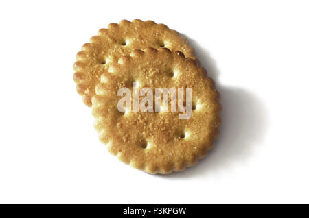 Classic round golden yellow salted cracker isolated on over white background Stock Photo