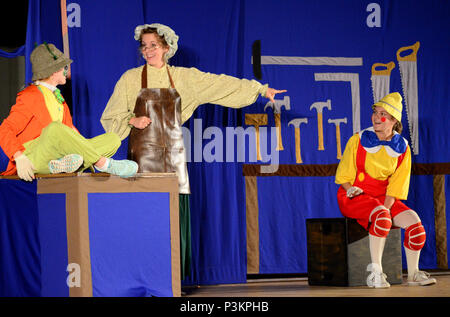 PETERSON AIR FORCE BASE, Colo.-  Mrs. Geppetto (Kate Kesslar) introduces Jiminy Cricket (Olivia Armstrong) to Pinocchio (Natalie Moran) during the Missoula Children’s Theatre presentation of Pinocchio at the base theater on Peterson Air Force Base on July 1, 2016. In a single year MCT has around 65,000 cast members, ages 5-18, performing before 750,000 people in all 50 states and 17 different countries. (U.S. Air Force photo by Staff Sgt. Amber Grimm) Stock Photo