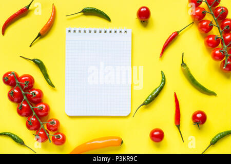 Assorted chili pepper tomato cherry On yellow bright background. Stock Photo