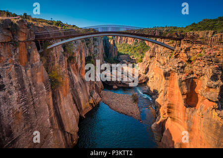 A wide shot of the river gorge and a high bridge at Bourke’s Luck Potholes in Mpumalanga, South Africa; a geological formation carved out by the movem Stock Photo