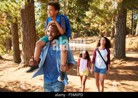 Family On Hiking Adventure Through Forest Stock Photo