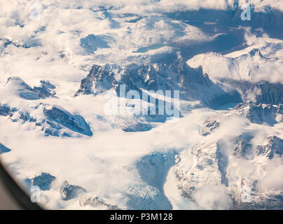 View from aeroplane window of snow covered Andes mountain peaks with glaciers, Southern Patagonian Ice field, Patagonia, Chile, South America Stock Photo