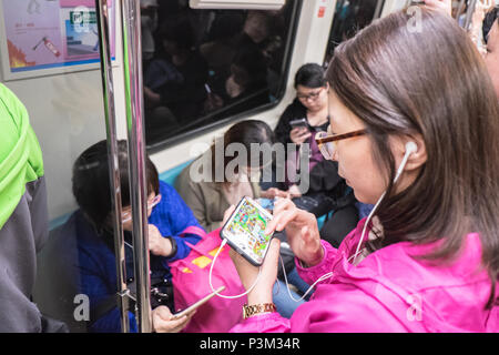 Using,mobile,MRT,metro,subway,train,rail,transport,transportation,Taipei City,Taipei,Taiwan,Taiwanese,Republic of China,ROC,China,Chinese,Asia,Asian, Stock Photo