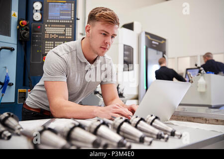 Male Engineer Using CAD Programming Software On Laptop Stock Photo