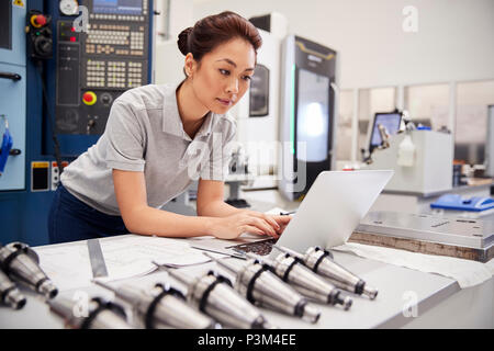 Female Engineer Using CAD Programming Software On Laptop Stock Photo