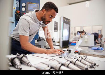 Male Engineer Using CAD Programming Software On Laptop Stock Photo