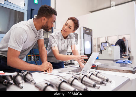 Two Engineers Using CAD Programming Software On Laptop Stock Photo