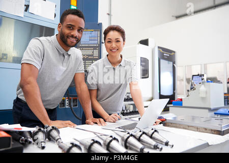 Portrait Of Engineers Using CAD Programming Software On Laptop Stock Photo