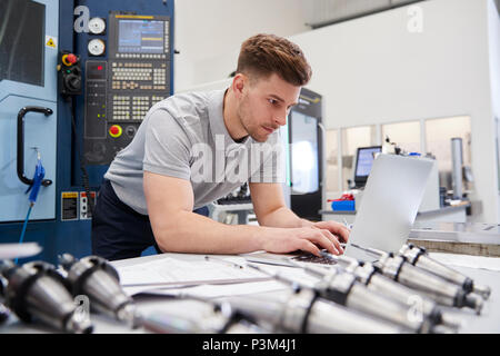 Male Engineer Using CAD Programming Software On Laptop Stock Photo