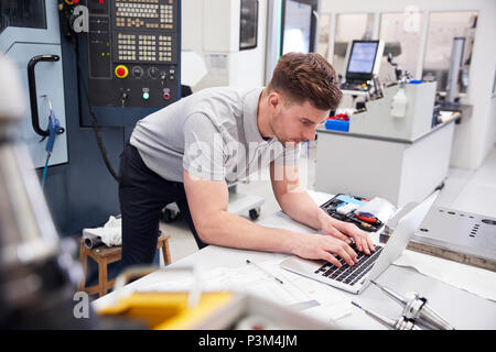 Male Engineer Using CAD Programming Software On Laptop Stock Photo