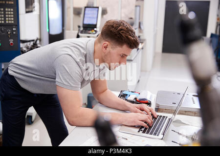 Male Engineer Using CAD Programming Software On Laptop Stock Photo