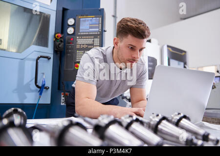 Male Engineer Using CAD Programming Software On Laptop Stock Photo