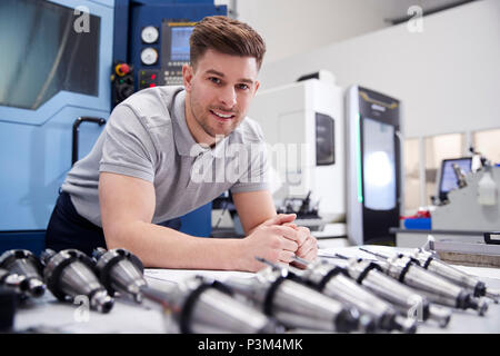 Portrait Of Male Engineer With CAD Drawings In Factory Stock Photo