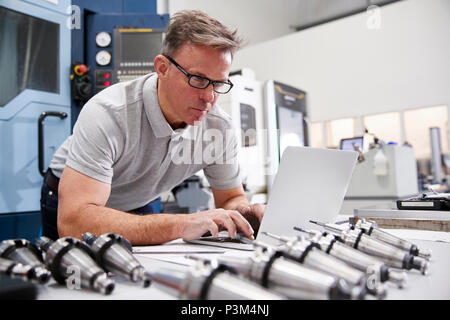 Male Engineer Using CAD Programming Software On Laptop Stock Photo