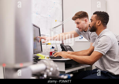 Male Engineers Use CMM Coordinate Measuring Machine In Factory Stock Photo