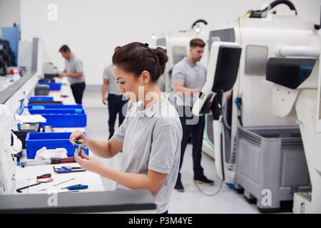 Female Engineer Quality Controlling Components In Factory Stock Photo