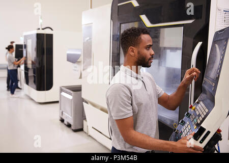 male engineer operating cnc machinery in factory Stock Photo - Alamy