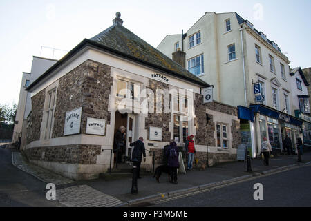 Lyme Regis England Fat face clothes shop stone building Fatface FATFACE WH Smiths houses shops step steps dog walk walking sign signs hill Stock Photo