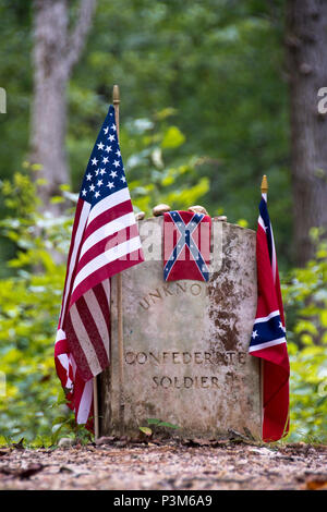 American and Confederate flags decorate graves of Confederate soldiers buried along the Natchez Trace in Mississippi. Stock Photo