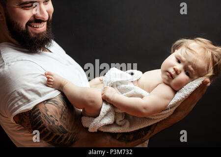 Father holding on hands cute little baby. Family, love and happiness concept Stock Photo