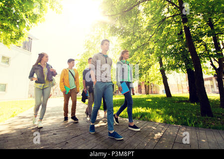 group of happy teenage students walking outdoors Stock Photo