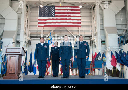 U.S. Air Force Brig. Gen. Ryan T. Okahara, Commander of the Hawaii Air National Guard, Senior Master Sgt. Charles R. Parker, 154th Wing First Sergeant, Brig. Gen. Gregory S. Woodrow, former Commander of the 204th Airlift Squadron, and Brig. Gen. Braden K. Sakai, former Commander of the 154th Wing, completes a change of command ceremony on Joint Base Pearl Harbor-Hickam, Hawaii, July 10, 2016.  The passing of colors is a time honored military tradition that represents the transfer of authority and responsibility of a unit from one commanding officer to another. (U.S. Air National Guard photo by Stock Photo