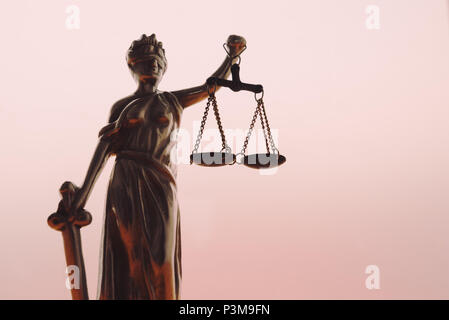 Statue of lady Justice or Justitia with scale on bright background Stock Photo