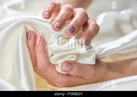 Gentle silk fabric in female hands. Stock Photo