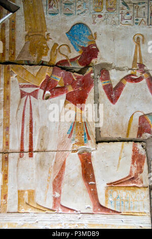 Colorfully painted bas relief stone carvings depict the pharaoh inside the Temple of Seti I, Abydos, Egypt. Stock Photo