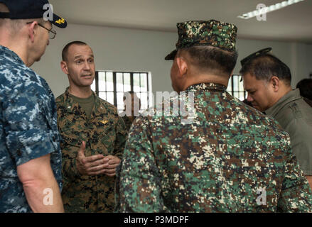 160708-M-TM809-489 LEGAZPI, Philippines (July 8, 2016) U.S. Marine Lt. Col. Andrew Rice, Pacific Partnership 2016 deputy chief of staff, speaks with partner nation guests and U.S. Navy Capt. Tom Williams, mission commander, Pacific Partnership 2016, at the end of a humanitarian assistance disaster relief workshop at the Disaster Coordination Center in Legazpi Airport in support of Pacific Partnership 2016. The three-day workshop, which was co-hosted by the Armed Forces of the Philippines and Pacific Partnership 2016, included Filipino civilians, U.S., New Zealand and Australian  service member Stock Photo