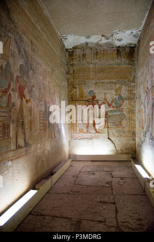 Colorfully painted bas relief carvings depict Pharaoh and the Egyptian gods inside the Great Osiris Temple built by Pepi I, Abydos, Egypt. Stock Photo