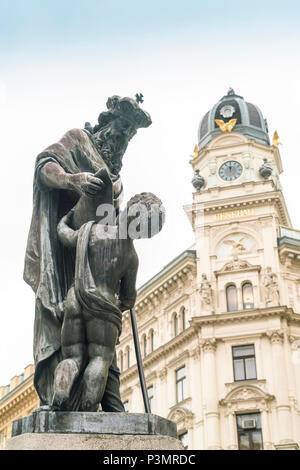 Statue of priest and child in Stephan's Square in Vienna, Austria Stock Photo