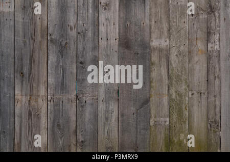 The texture of weathered wooden wall. Aged wooden plank fence of vertical flat boards Stock Photo