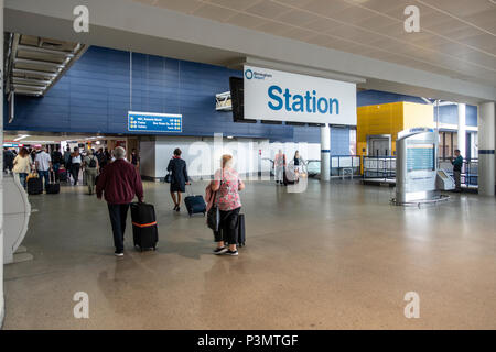 Passengers arriving at Birmingham International Station from the air link from the airport. Some motion blur in some of the people. Stock Photo