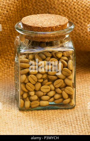 Green coffee beans in a jar on burlap Stock Photo