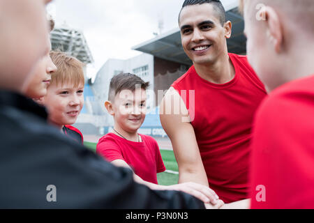 Junior Football Team Huddling before Match Stock Photo