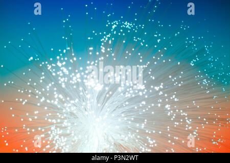 Futuristic technological background. Closeup on the end of optical fiber network cable on blue-orange background. Shallow DOF, blurred image, no focal Stock Photo