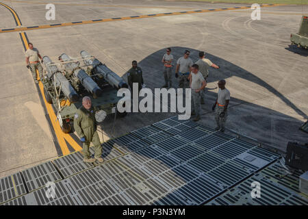 U.S. Air Force Master Sgt. Dan Warman, a loadmaster assigned to the 709th Airlift Squadron, demonstrates how to load cargo onto a U.S. Air Force Lockheed C-5 Galaxy transport aircraft at McEntire Joint national Guard Base, S.C., July 8, 2016. Approximately 300 U.S. Airmen and 12 F-16 Fighting Falcons from the 169th Fighter Wing at McEntire JNGB, S.C., are deploying to Osan Air Base, Republic of Korea, as the 157th Expeditionary Fighter Squadron in support of the U.S. Pacific Command Theater Security Package. (U.S. Air National Guard photo by Airman 1st Class Megan Floyd) Stock Photo