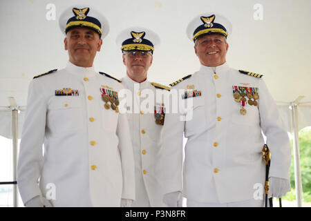NEW YORK – Capt. Andrew Tucci, commander Sector Long Island Sound, stands with Rear Adm. Steven Poulin, commander of Coast Guard First District, and retired Capt. Edward Cubanski during a change of command ceremony at the sector in New Haven, Connecticut, July 8, 2016. Cubanski spent 28 years in the Coast Guard, many of which were spent in the aviation field. (U.S. Coast Guard photo by Petty Officer 3rd Class Steve Strohmaier) Stock Photo