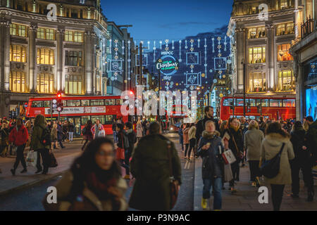 London, UK - November 2017. Decorated Oxford Circus crowded with people shopping for Christmas. Landscape format. Stock Photo