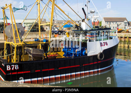 7 June 2018 Various colourful fishing trawlers tied up in the calm waters of Kilkeel Harbour in County Down Northern Ireland Stock Photo