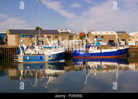 7 June 2018 Various colourful fishing trawlers tied up in the calm waters of Kilkeel Harbour in County Down Northern Ireland Stock Photo