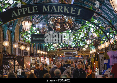 London, UK - November 2017. A crowded Christmas decorated Apple Market in Covent Garden. Landscape format.