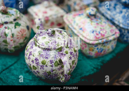 Vintage tea pot with floral decoration. Landscape format. Stock Photo