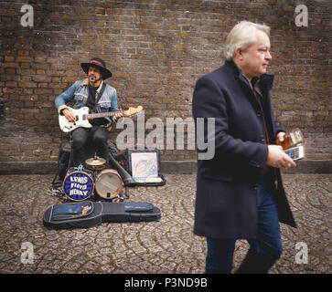 London, UK - December 2017. A Jimi Hendrix look-alike street musician performing in Brick Lane. Landscape format. Stock Photo