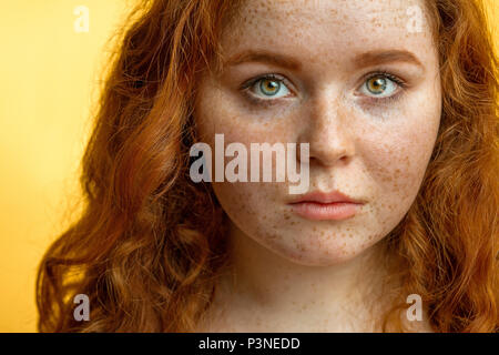 Close-up of beautiful red-haired freckled girl with loose curly hair Stock Photo