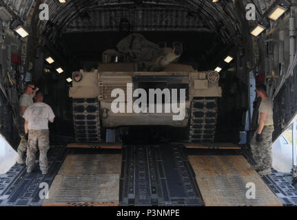 Sgt. 1st. Class. Richard Erskine, a jumpmaster for 1st Brigade Combat Team,  82nd Airborne Division, demonstrates how to properly hook up his static line  during a pre-jump class at Robert Gray Army