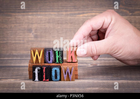 Work flow business concept. Wooden letters on the office desk, communication background Stock Photo